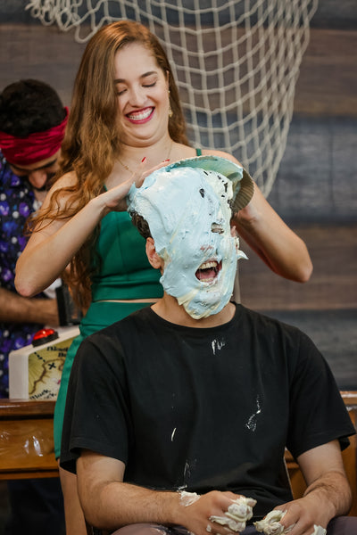 Guy take pies in the face from a girl