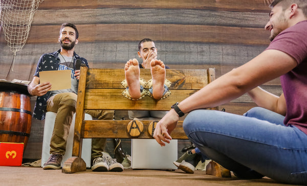 male feet in stocks